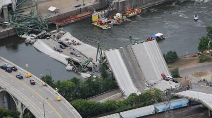 An aerial view shows the collapsed I-35W